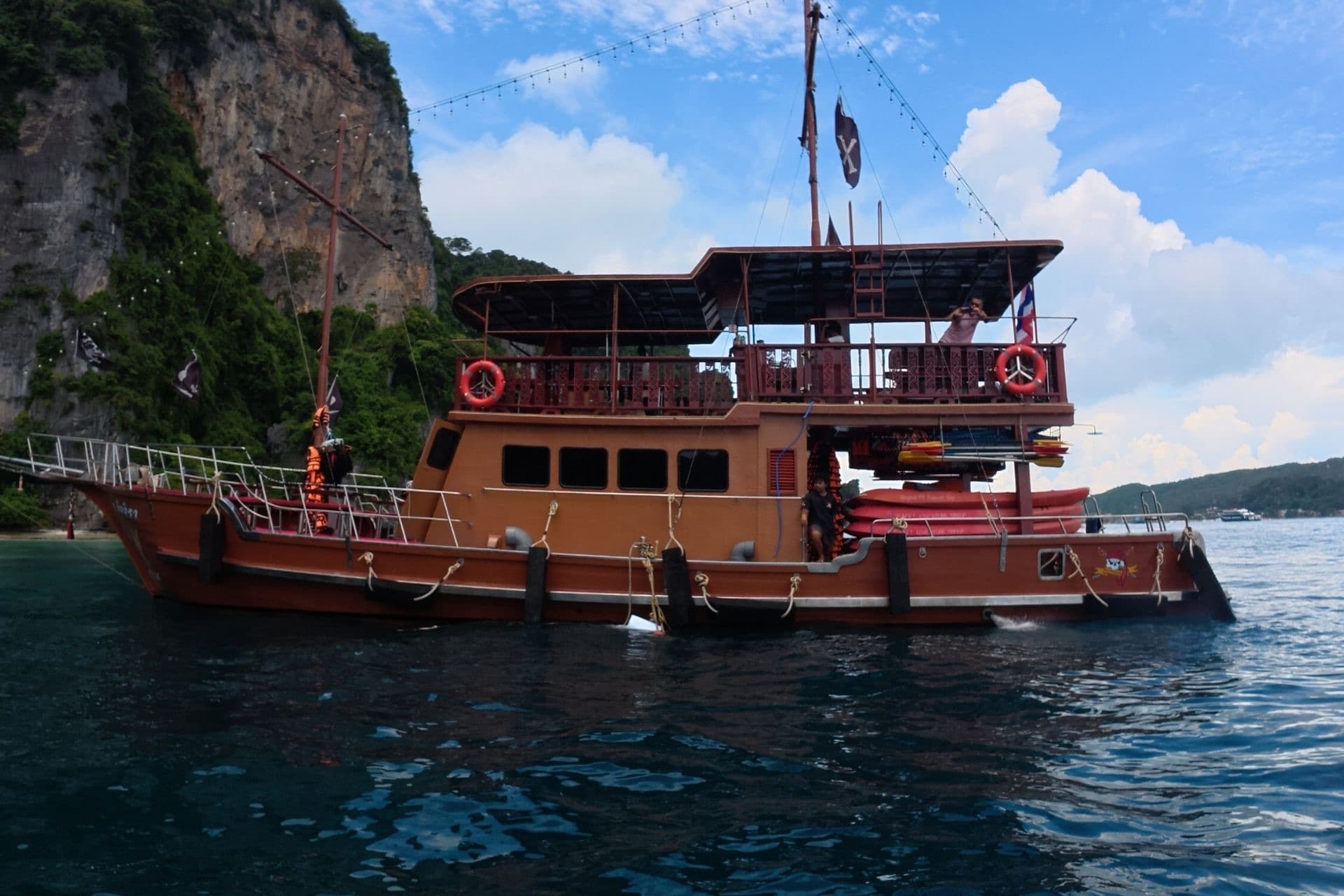 The Phoenix moored beside a limestone cliff